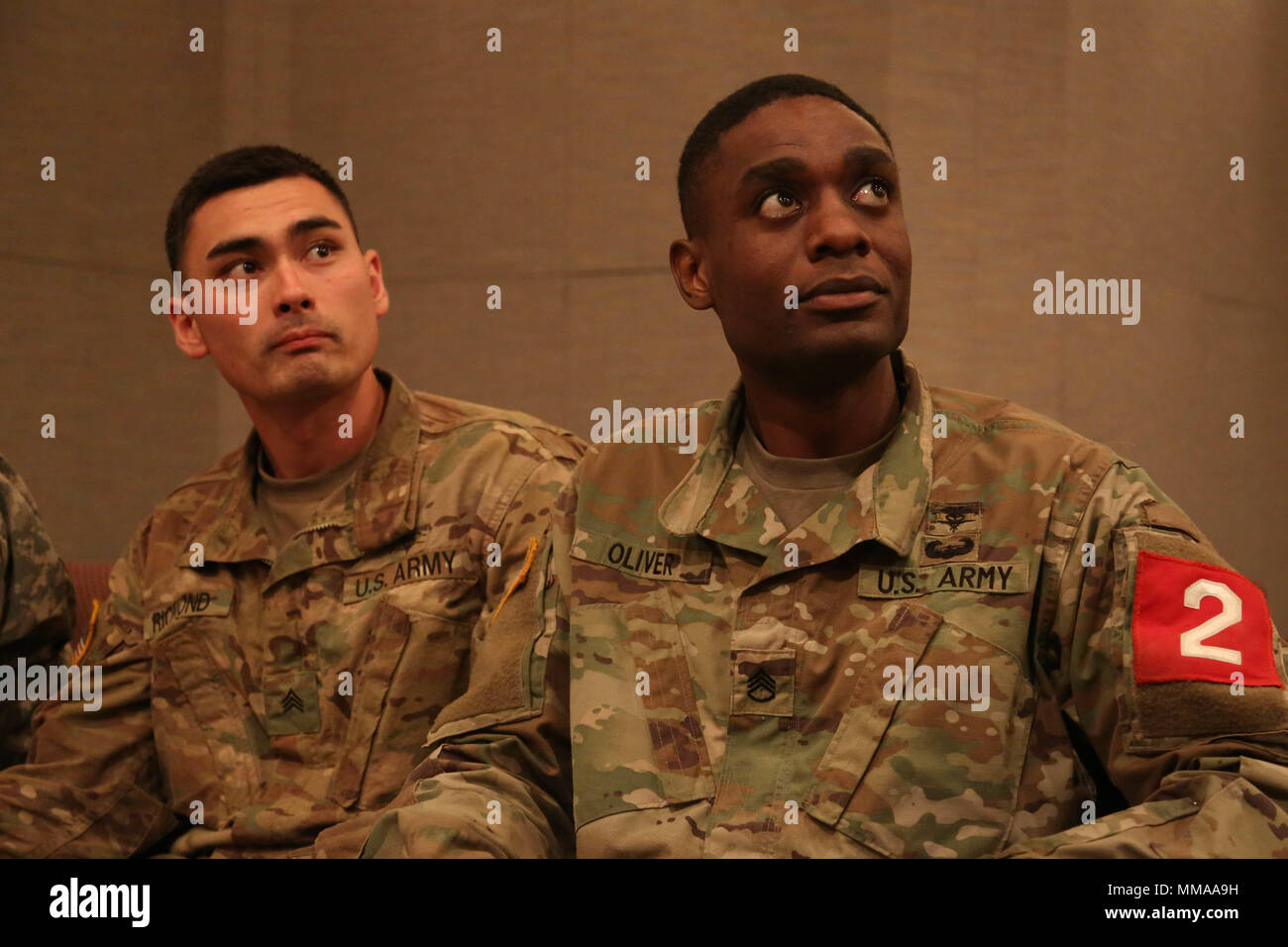 U.S. Army Sgt. Kevin Richmond and Staff Sgt. Brandon Oliver, assigned to the Martin Army Community Hospital, listen to speakers during the 2017 Best Medic Competition Award Ceremony at Fort Bragg, N.C., Sept. 20, 2017. The competition tested the physical and mental toughness, as well as the technical competence, of each medic to identify the team moving forward to represent the region at the next level of the competition.  (U.S. Army photo by Pfc. Meleesa Gutierrez) Stock Photo