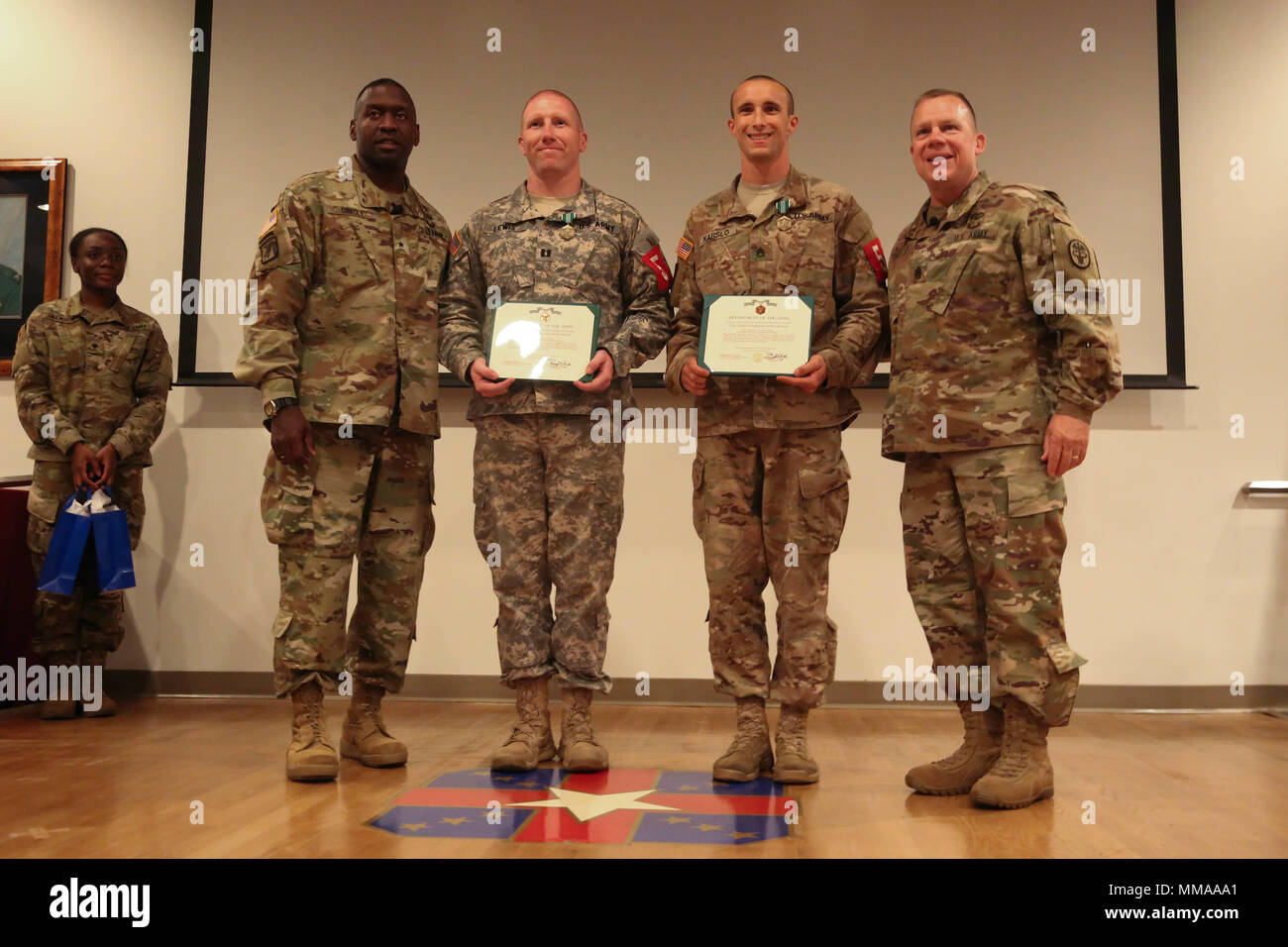U.S. Army Capt. Jeremy Lewis and Staff Sgt. Joseph Karslo, assigned Public Health Command - Atlantic, take a photo with Brig. Gen. R. Scott Dingle and Command Sgt. Maj. Matthew Brady during the 2017 Best Medic Competition Award Ceremony at Fort Bragg, N.C., Sept. 20, 2017. The competition tested the physical and mental toughness, as well as the technical competence, of each medic to identify the team moving forward to represent the region at the next level of the competition.  (U.S. Army photo by Pfc. Meleesa Gutierrez) Stock Photo