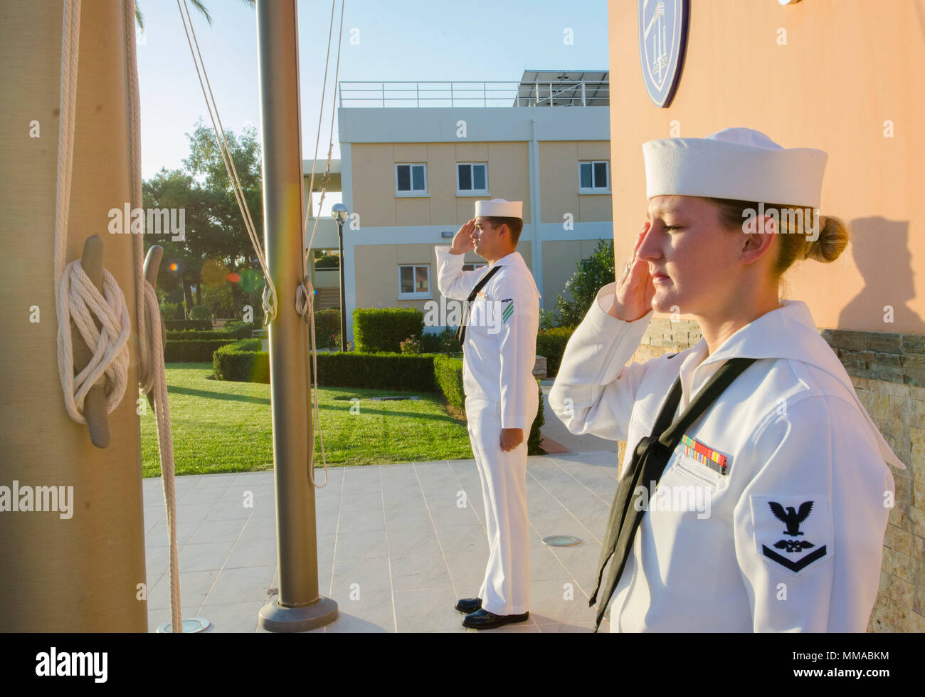 NAVAL SUPPORT ACTIVITY SOUDA BAY, Greece (NNS) - Aviation Boatswains Mate  (Handling) 3rd Class Petty Officer Kelli Gray and Aviation Boatswains Mate  (Handling) Seaman Micahal Tarwater lower both the U.S. and Greek flags to  half-mast during morning colors onboard Naval Support Activity (NSA) Souda  Bay.  President Donald J. Trump ordered all U.S. flags to half-staff as a  mark of respect for the victims and their families of the mass shooting that  occurred in Las Vegas on Sunday, October 1, 2017.  (U.S. Navy photo by Jacky  Fisher/released) Stock Photo