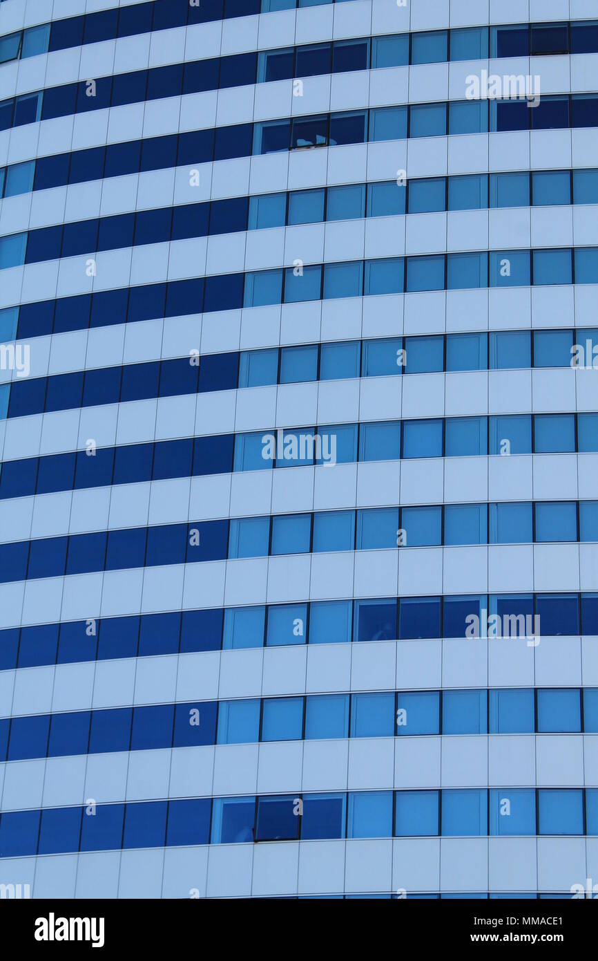 White architectural structure with blue sky background with blue windows Stock Photo