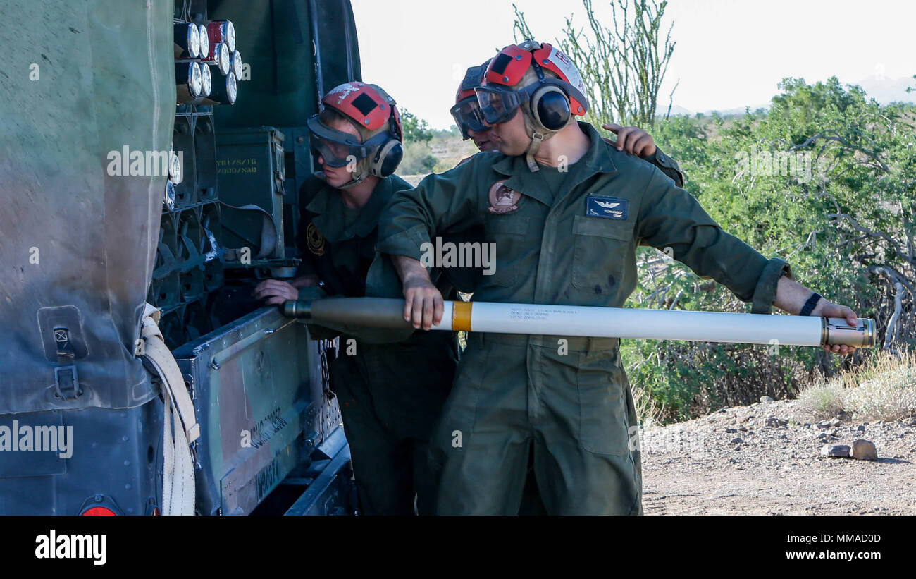 U.S. Marines with Marine Aviation Weapons and Tactics Squadron One (MAWTS-1), prepare to load a 2.75 inch rocket during Weapons and Tactics Instructors Course (WTI) 1-18 at Chocolate Mountain, Aerial Gunnery Range, Calif., Oct 03, 2017. WTI is a seven-week training event hosted by Marine Aviation Weapons and Tactics Squadron (MAWTS-1) cadre, which emphasizes operational integration of the six functions Marine Aviation in support of a Marine Air Ground Task Force. MAWTS-1 provides standardized advanced tactical training and certification of unit instructor qualifications to support Marine Aviat Stock Photo