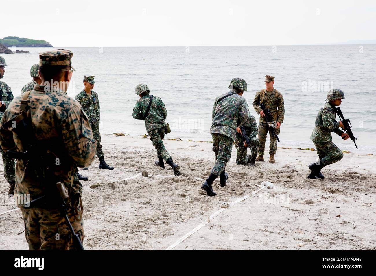 U.S. and Philippine Marines tape off the beach to simulate the dimensions of a room while conducting room clearing exercises at Marine Base Gregorio Lim, Ternate, Philippines, Oct. 2. The Marines are participating in KAMANDAG, a bilateral exercise that increases the ability of the U.S. and the Philippines to rapidly respond to terrorist threats and humanitarian crises. KAMANDAG is an acronym for the Filipino phrase 'Kaagapay Ng Maddirigma Ng Dagat,' which translates to 'Cooperation of Warriors of the Sea.' (U.S. Embassy Manila courtesy photo by Paul Putong) Stock Photo