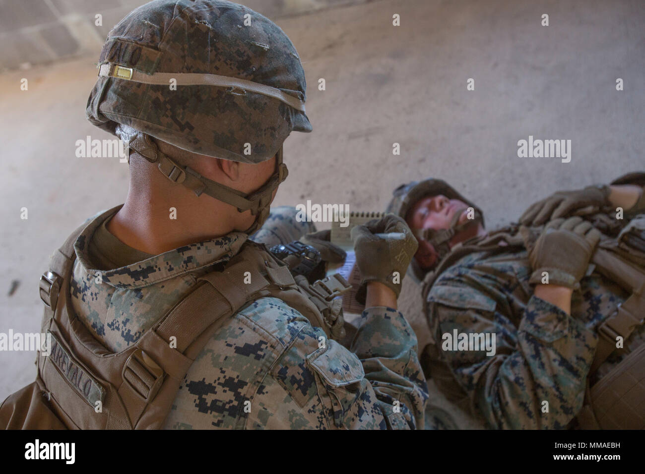 A Marine with 2nd Battalion, 8th Marine Regiment writes down casualty information during a military operation on urbanized terrain exercise at Camp Lejeune, N.C., Oct. 3, 2017. The Marines conducted MOUT training in preparation for their upcoming deployment to Japan. (U.S. Marine Corps photo by Lance Cpl. Ashley McLaughlin) Stock Photo