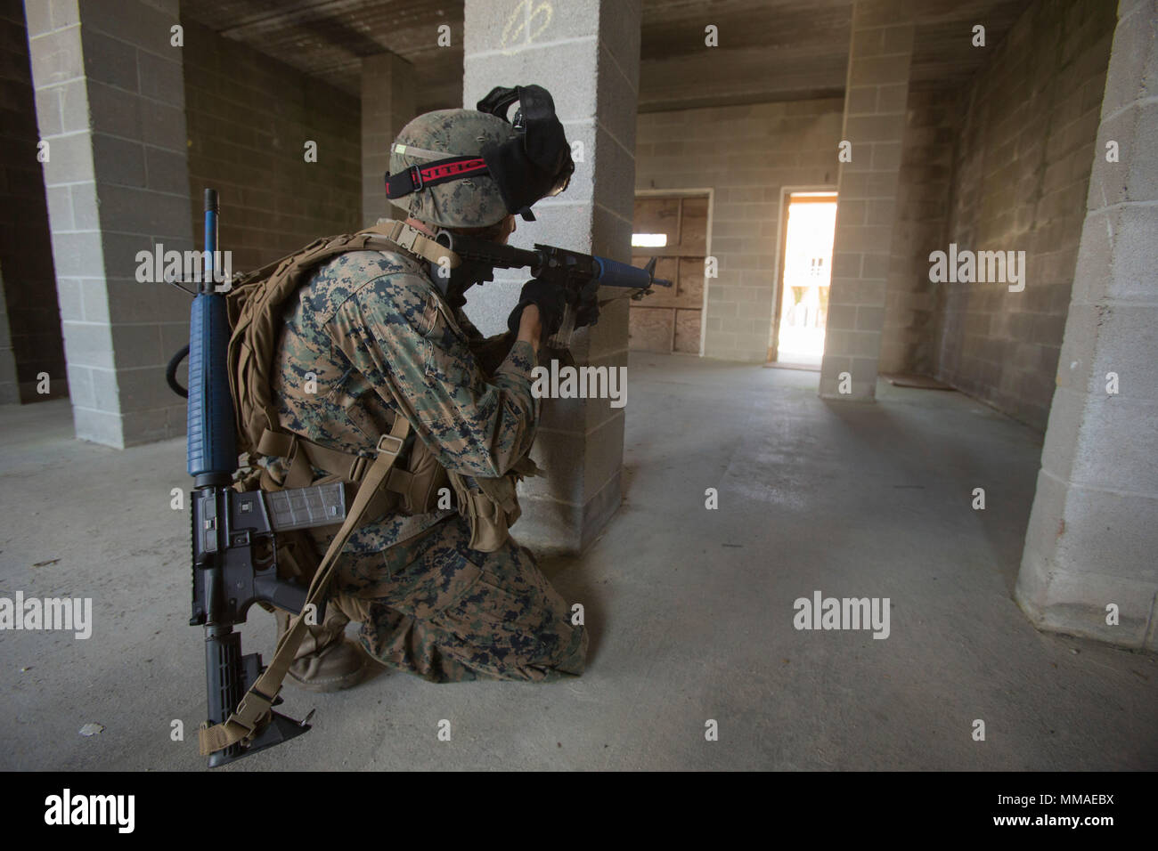 A Marine with 2nd Battalion, 8th Marine Regiment posts security during a military operation on urbanized terrain exercise at Camp Lejeune, N.C., Oct. 3, 2017. The Marines conducted MOUT training in preparation for their upcoming deployment to Japan. (U.S. Marine Corps photo by Lance Cpl. Ashley McLaughlin) Stock Photo