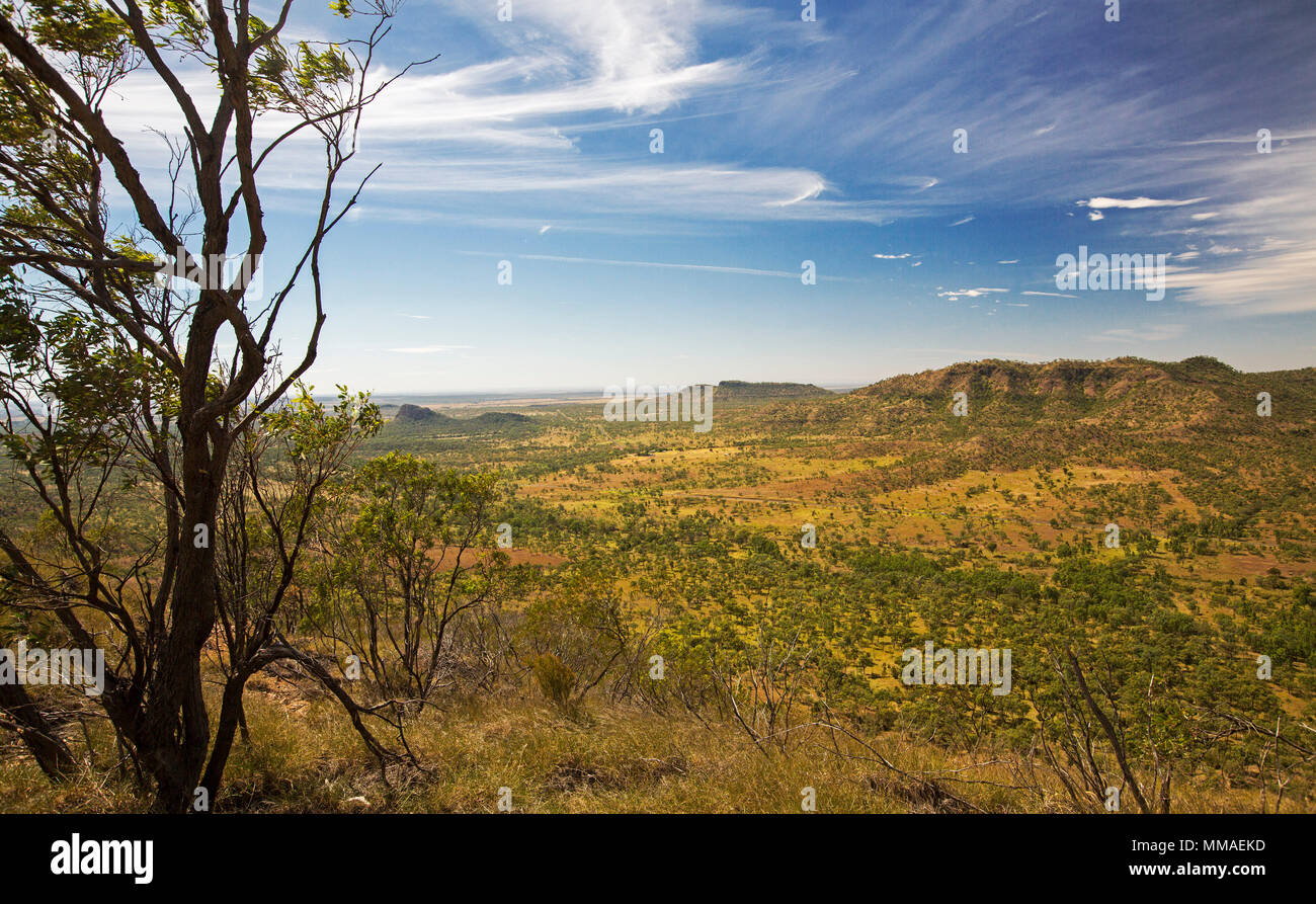 View of vast outback landscape of ranges and plains under blue sky from lookout at Minerva Hills National Park, near Springsure Queensland Australia Stock Photo