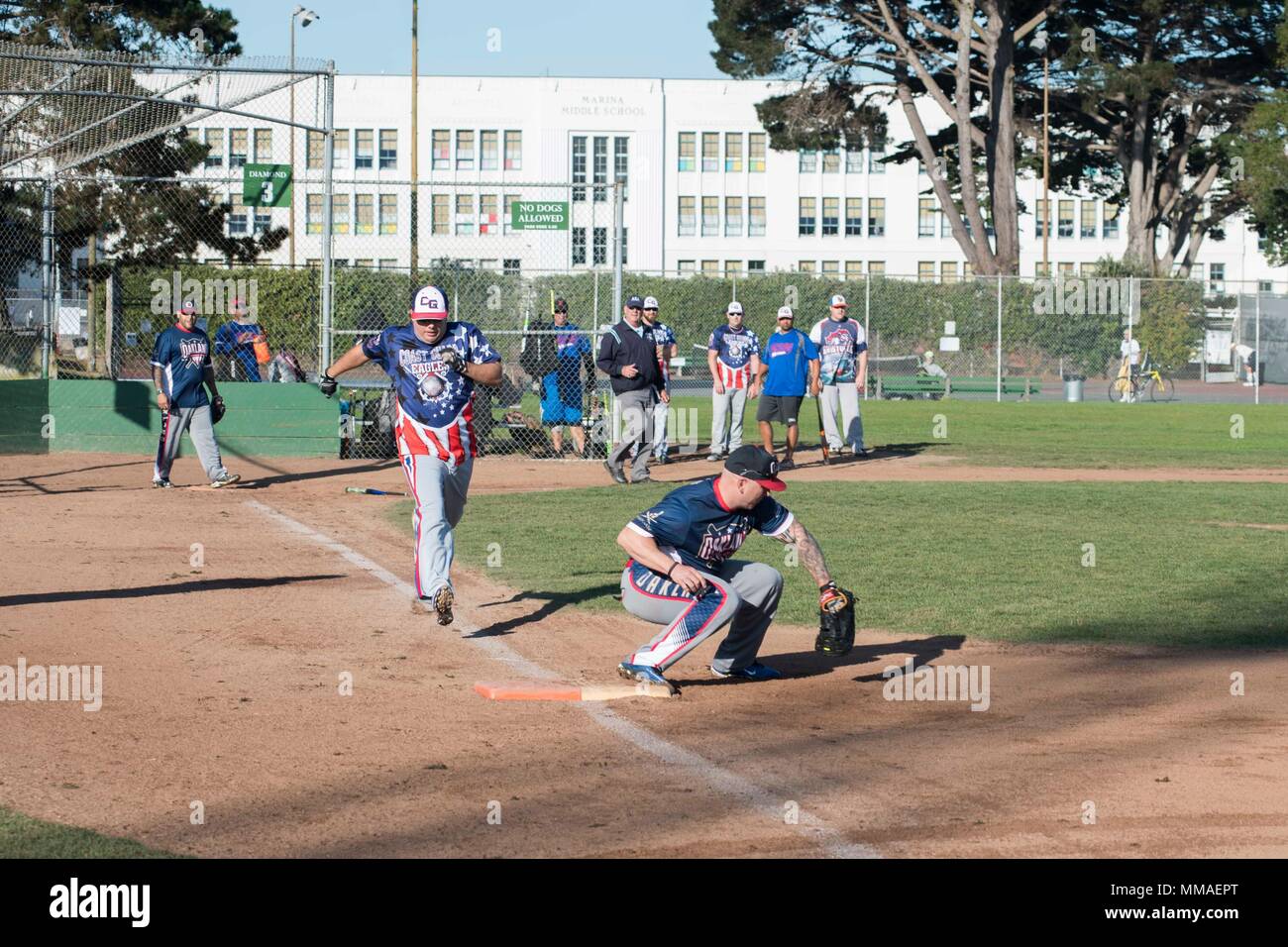 SAN FRANCISCO (Oct. 5, 2017) U.S. Coast Guard personnel play against members of the Oakland Police Department at a softball tournament during Fleet Week San Francisco.  Fleet week provides an opportunity for the American public to meet their Navy, Marine Corps, and Coast Guard team and to experience America's sea services, highlighting naval personnel, equipment, technology, and capabilities, with an emphasis on humanitarian assistance and disaster response.  (U.S. Navy photo by Mass Communication Specialist 2nd Class Chelsea Troy Milburn) Stock Photo