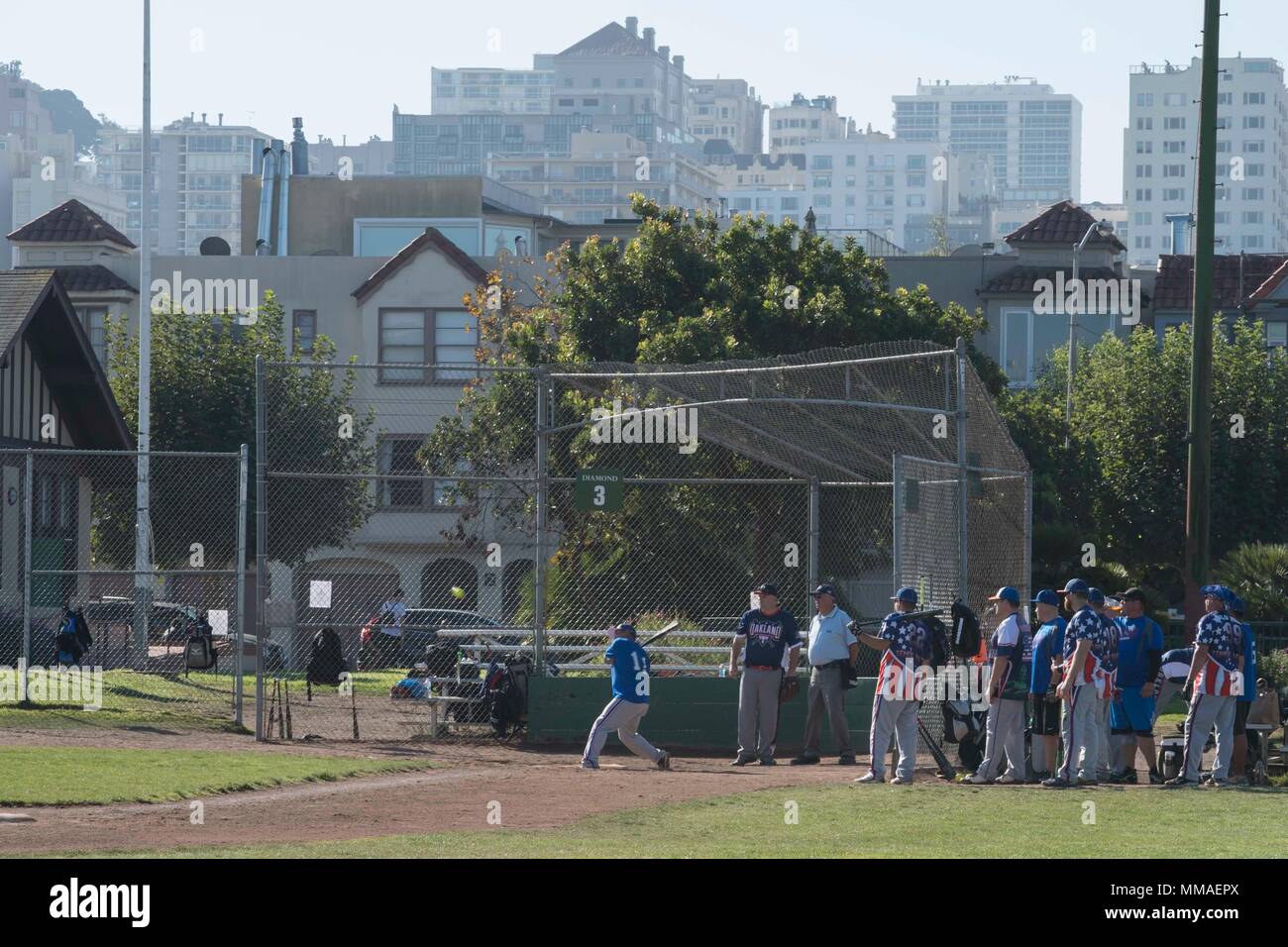 SAN FRANCISCO (Oct. 5, 2017) U.S. Coast Guard personnel play against members of the Oakland Police Department at a softball competition during Fleet Week San Francisco.  Fleet week provides an opportunity for the American public to meet their Navy, Marine Corps, and Coast Guard team and to experience America's sea services, highlighting naval personnel, equipment, technology, and capabilities, with an emphasis on humanitarian assistance and disaster response.  (U.S. Navy photo by Mass Communication Specialist 2nd Class Chelsea Troy Milburn) Stock Photo