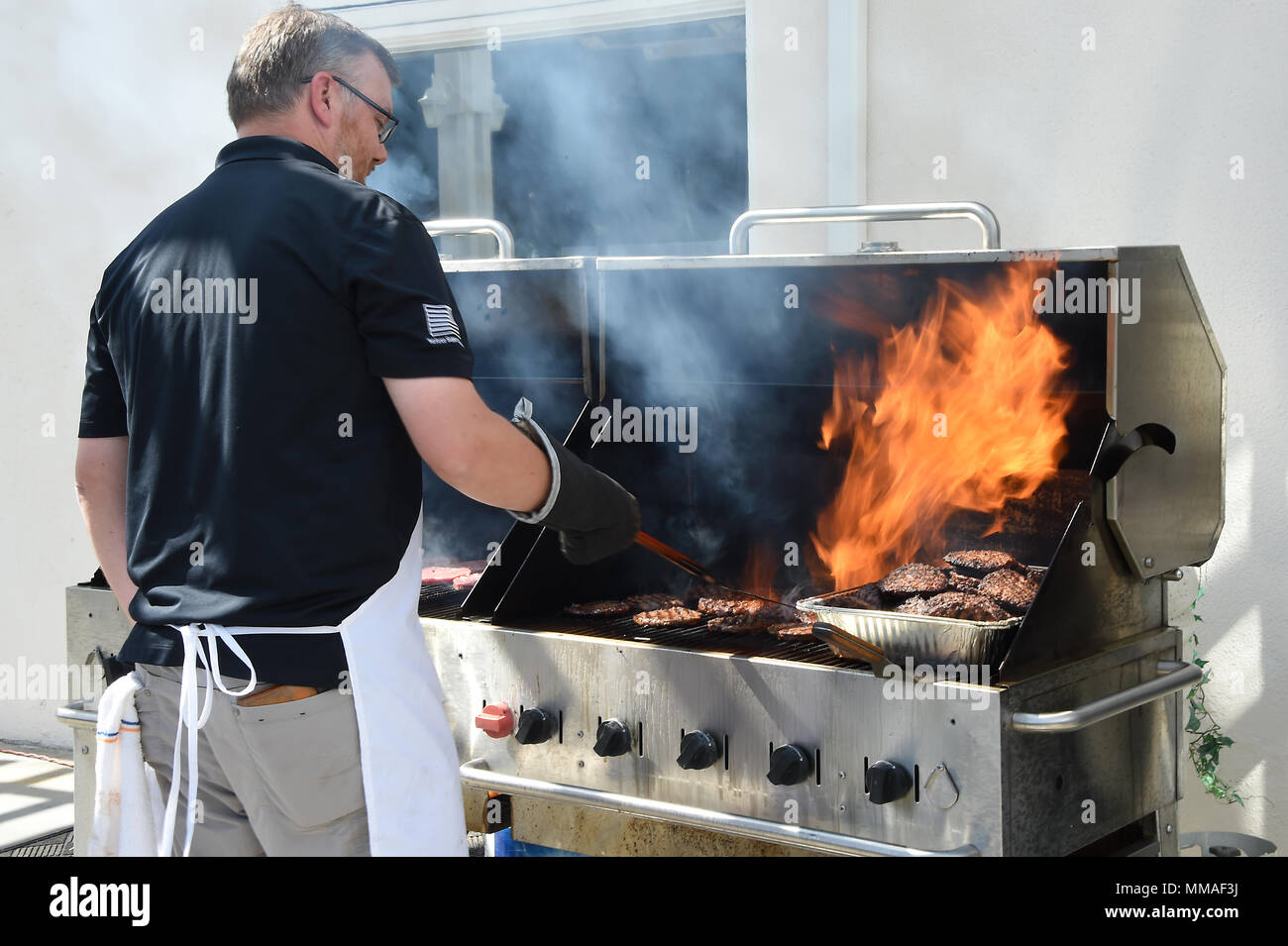 Approximately 1400 hamburgers and hot dogs were served at Sports Day. Military and Air Force civilian employees at Los Angeles Air Force Base, 61st Air Base Group and Space and Missile Systems Center, Calif., gather at the Fort MacArthur parade field in San Pedro, Calif. Oct. 4, 2016, to participate in “Sports Day” for a little squadron and inter-directorate competition in a variety of sports venues. The games foster physical, mental, and spiritual health and well-being, and a chance to win over-all points for the unit trophy, not to mention bragging rights between the SMC Directorates and 61s Stock Photo