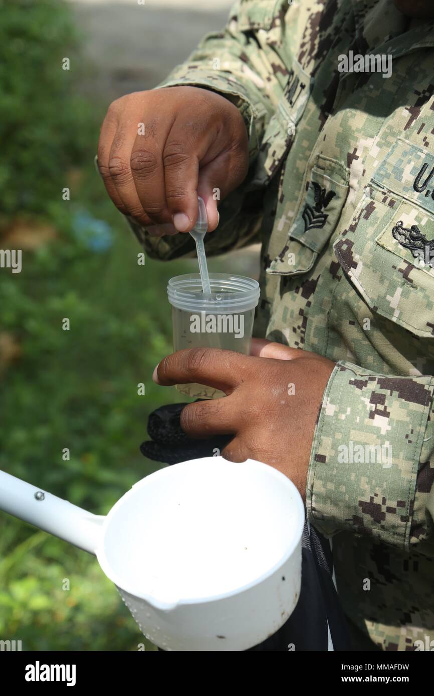 171003-A-NY041-0256 PUERTO BARRIOS, Guatemala (Oct. 3, 2017) U.S. Navy Hospital Corpsman 1st Class Dominic Ladmirault, assigned to Navy Entomology Center of Excellence, collects mosquito larvae from local neighborhoods for insect and disease control, during Southern Partnership Station 17 (SPS 17). SPS 17 is a U.S. Navy deployment, executed by U.S. Naval Forces Southern Command/U.S. 4th Fleet, focused on subject matter expert exchanges with partner nation militaries and security forces in Central and South America. (U.S. Army photo by SGT Crystal Madriz/Released) Stock Photo