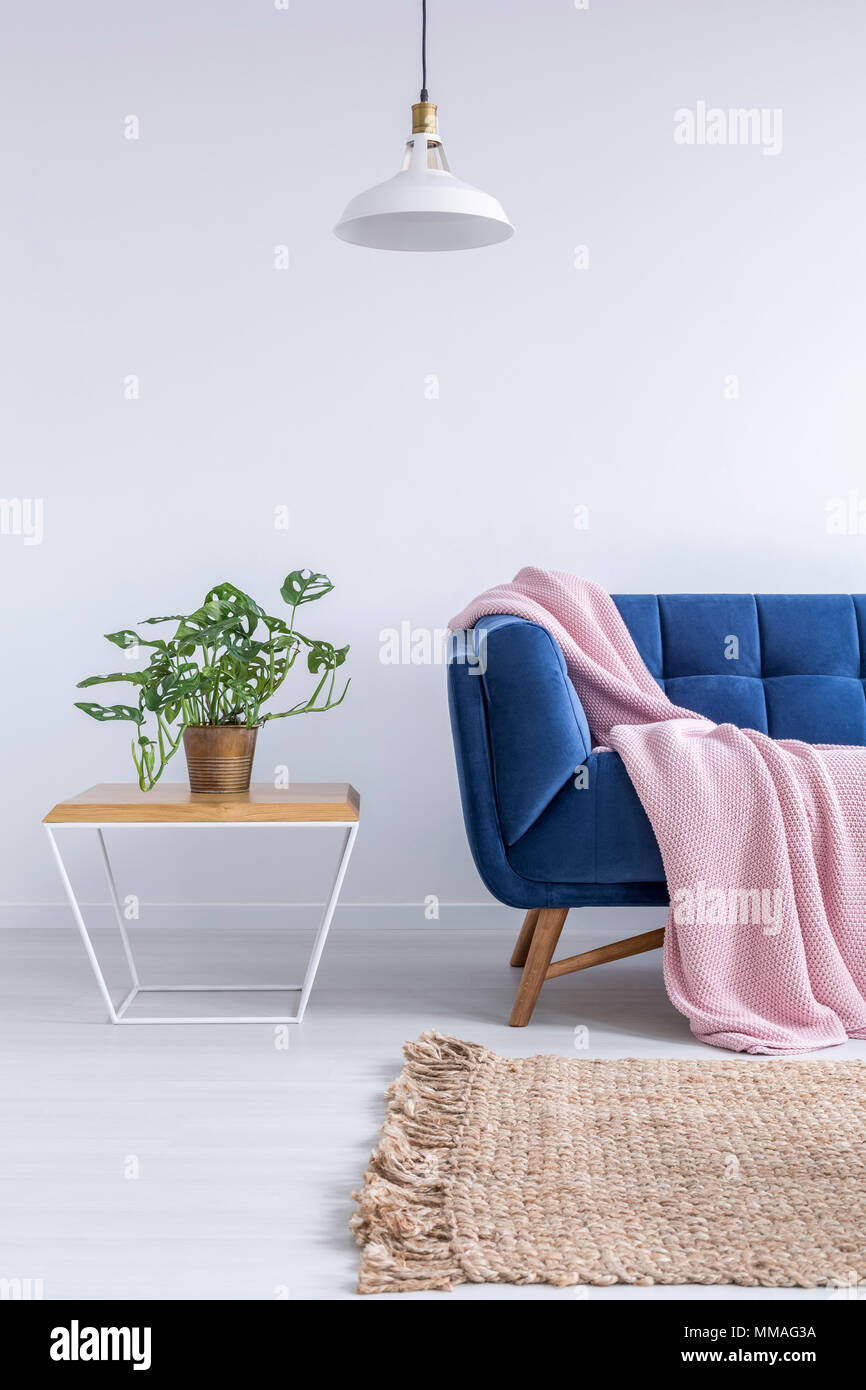 Beautiful room with blue sofa, rug, lamp and wood table Stock Photo - Alamy