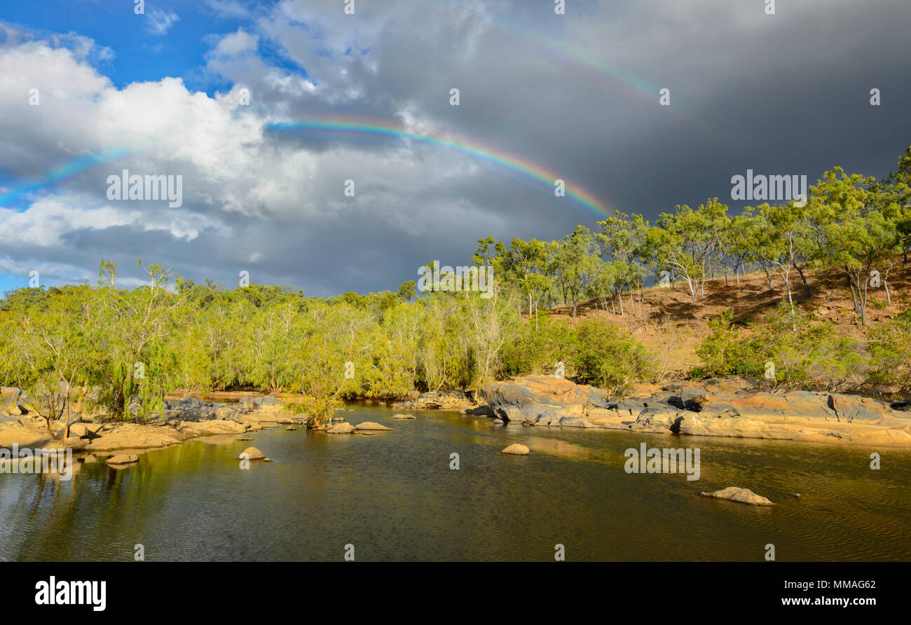 Black clouds and rainbow over bushland in Palmer River Goldfield, Far North Queensland, FNQ, QLD, Australia Stock Photo