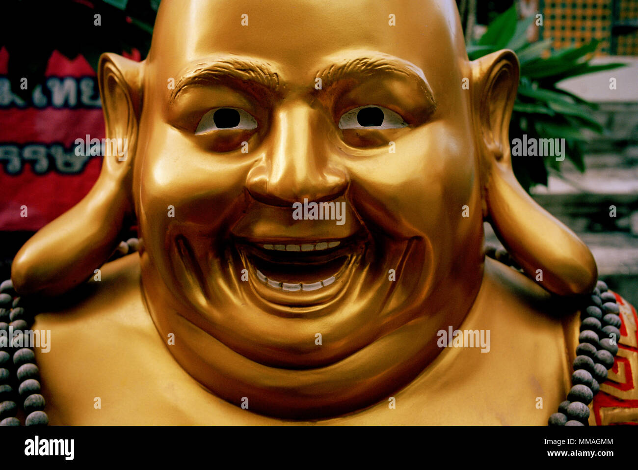 Humour - Happy Buddha at Wat Arun - Temple of Dawn in Thonburi in Bangkok in Thailand in Southeast Asia Far East. Humor Buddhism Buddhist Travel Stock Photo