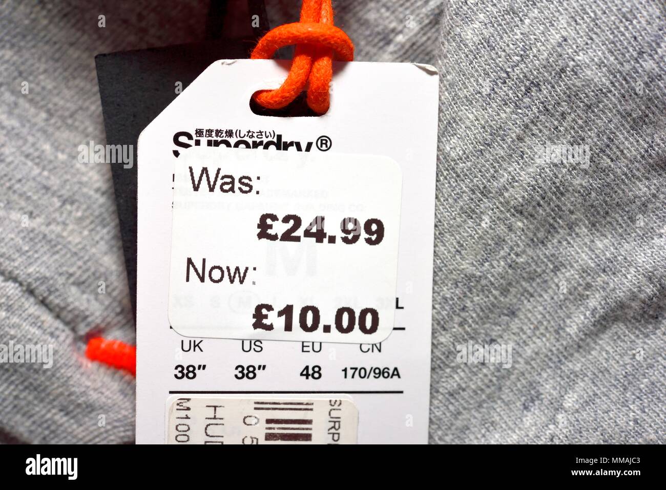 Was now reduced clothing pricing label Stock Photo