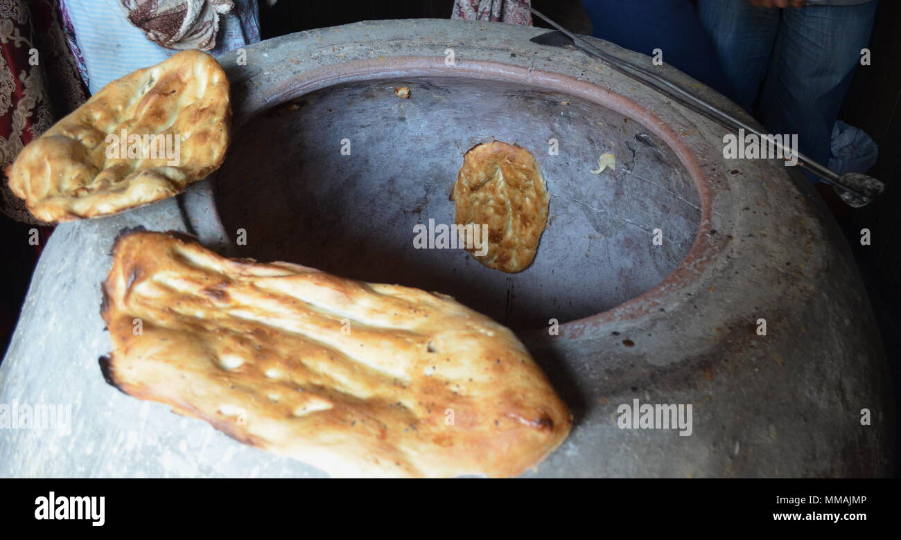 Traditional Azerbaijan way of baking lavash bread in an oven Stock