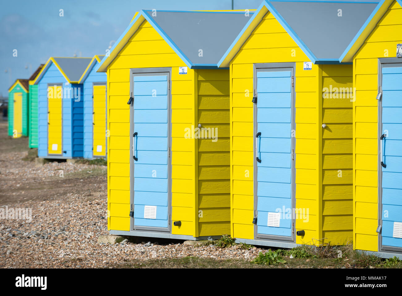 A row of coloured beach huts on the pebble beach at Littlehampton in