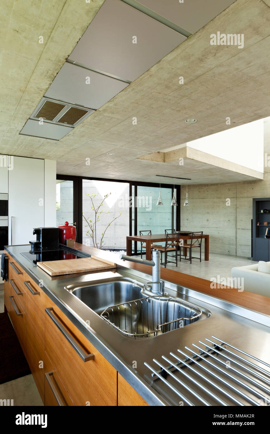 beautiful modern house in cement, interior, wooden kitchen island Stock Photo