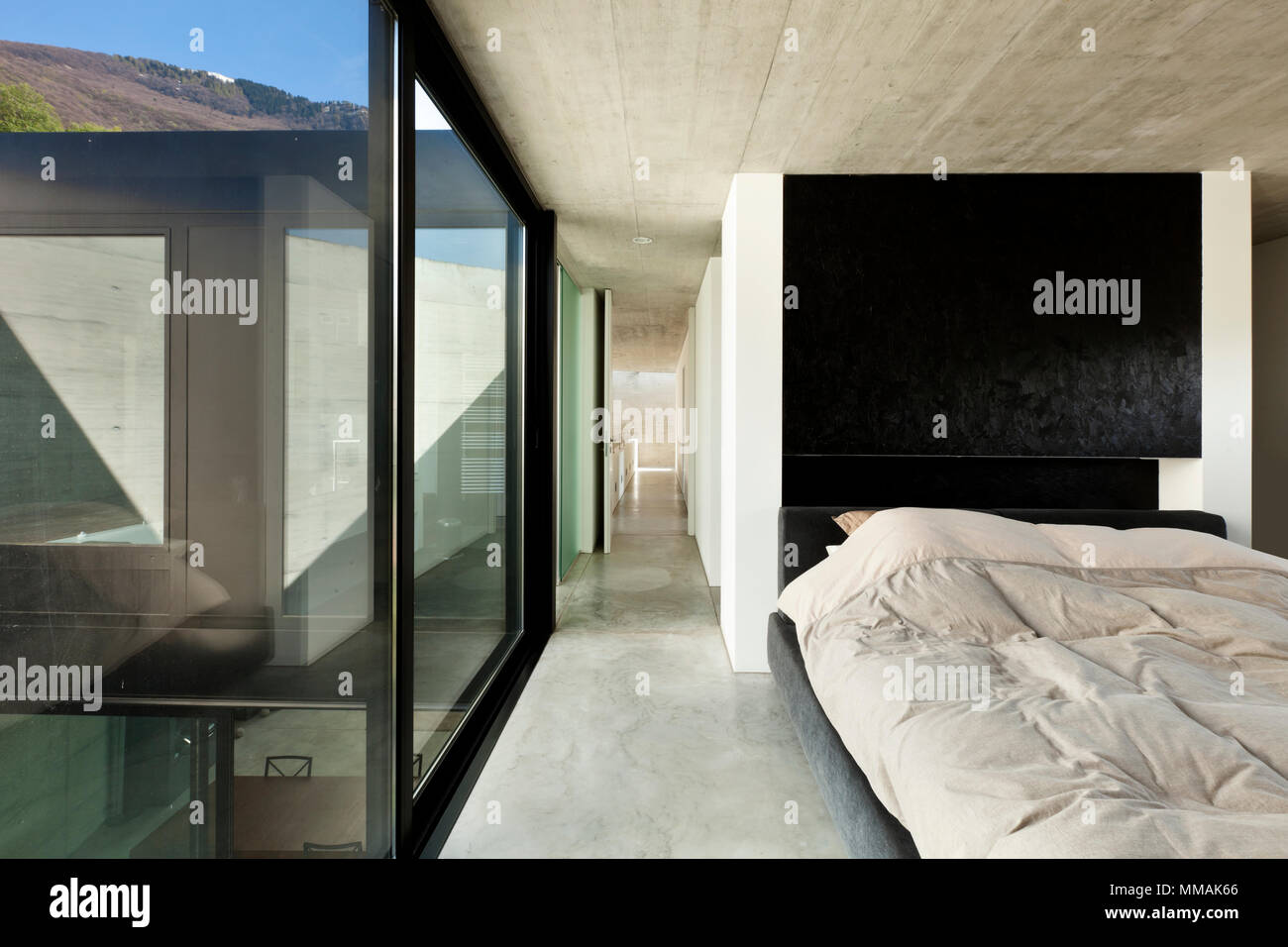 beautiful modern house in cement, interior, bedroom Stock Photo - Alamy