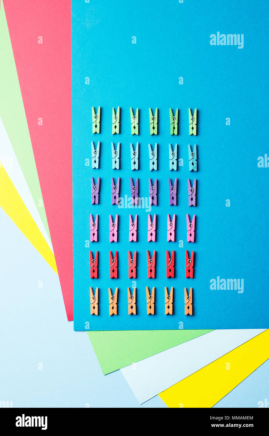 Laundry clips organized over colorful background, top view Stock Photo