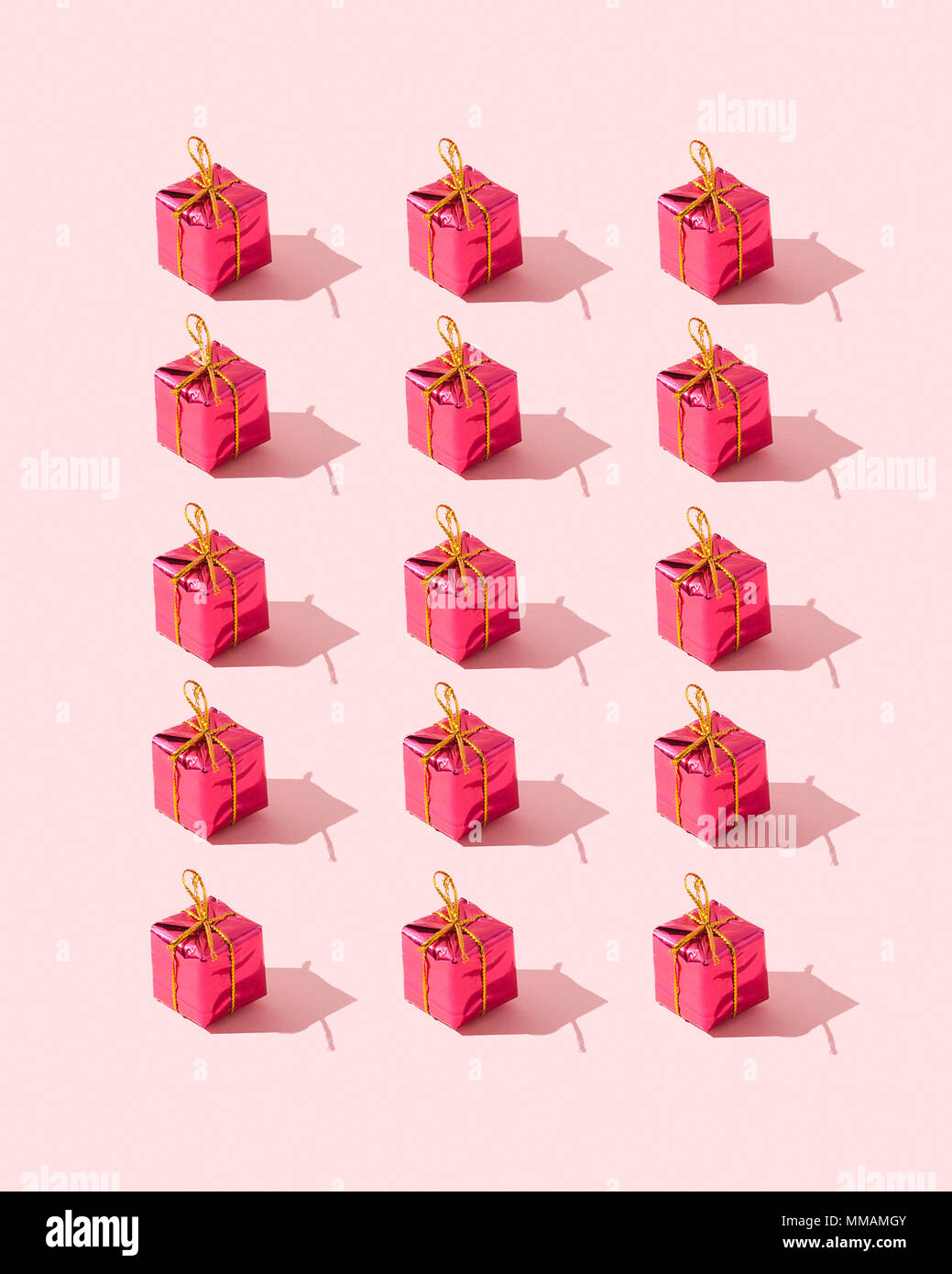 Small gift boxes organized over pink background Stock Photo