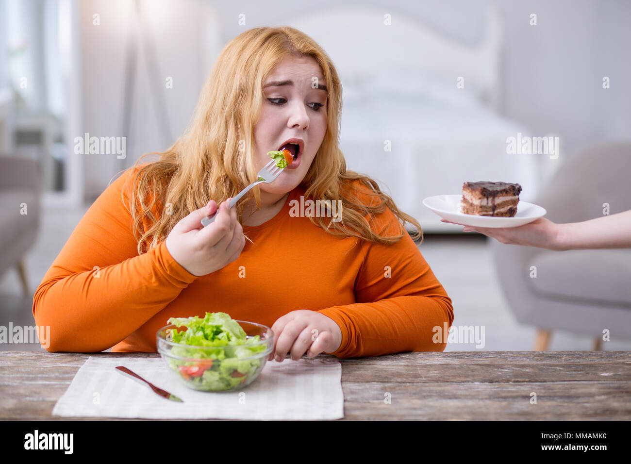 Sad fat woman eating healthy breakfast Stock Photo