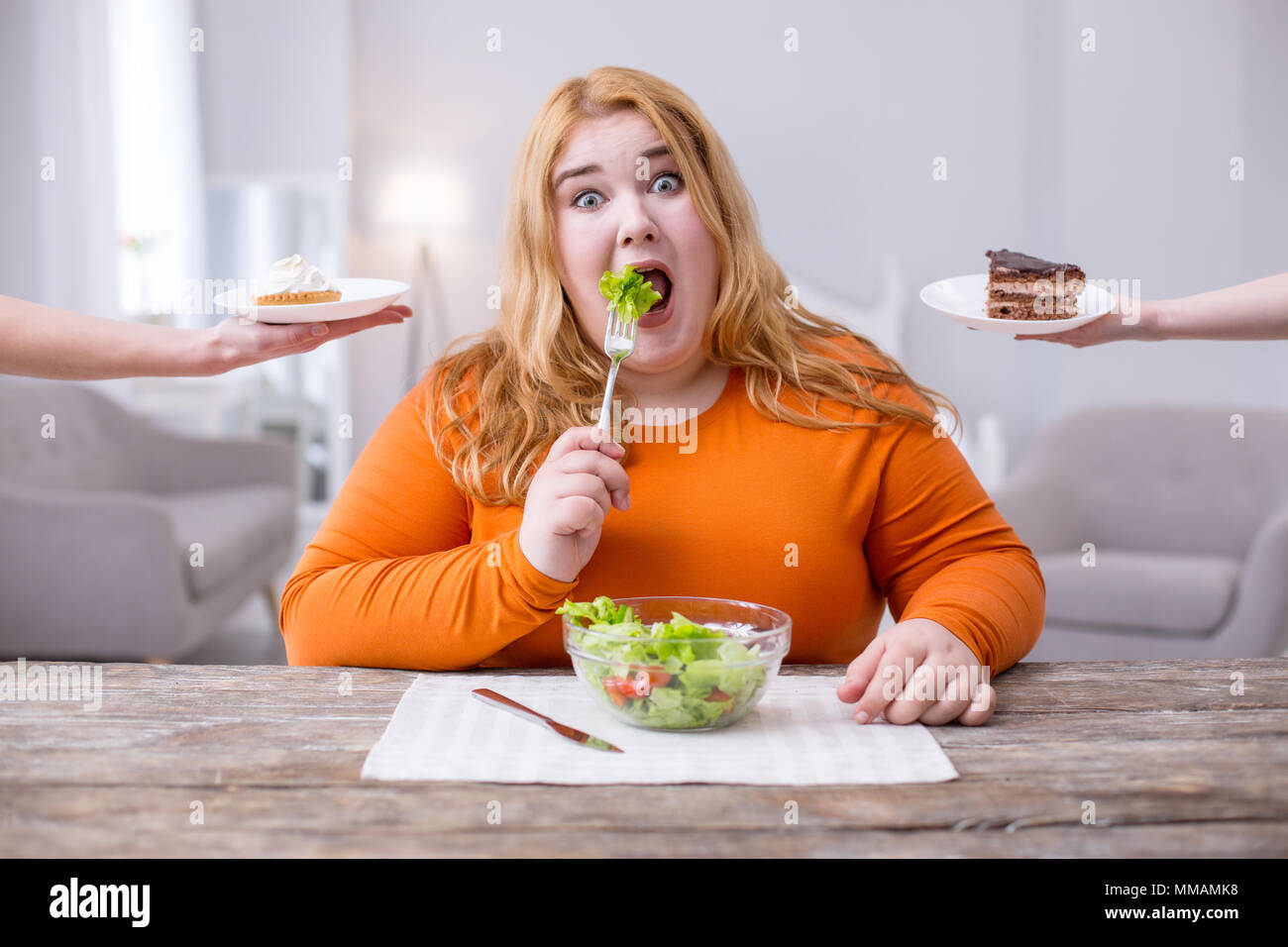 Melancholic fat woman eating healthy breakfast Stock Photo