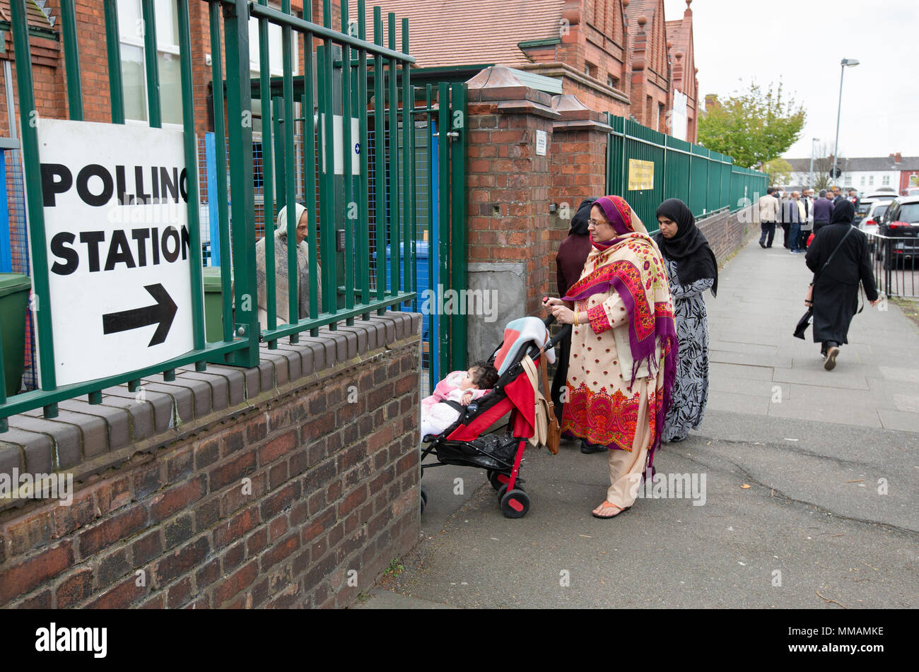 Muslim voters arriving at a polling station in Small Heath, Birmingham, for the local elections in May 2018. Stock Photo