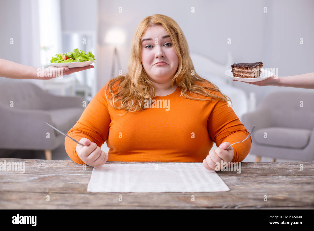 Sad overweight woman being on a diet Stock Photo