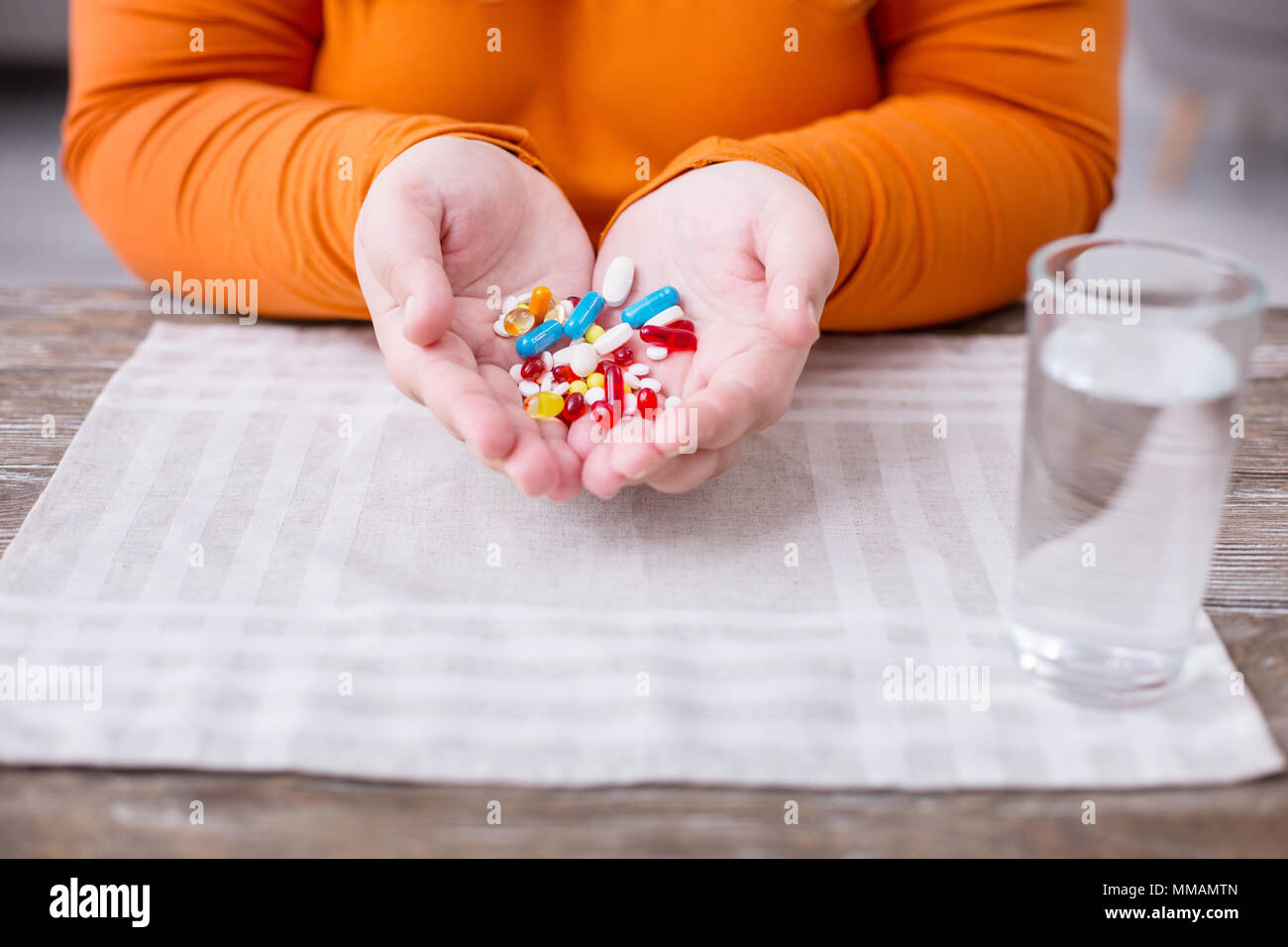 Overweight woman colourful little pills Stock Photo