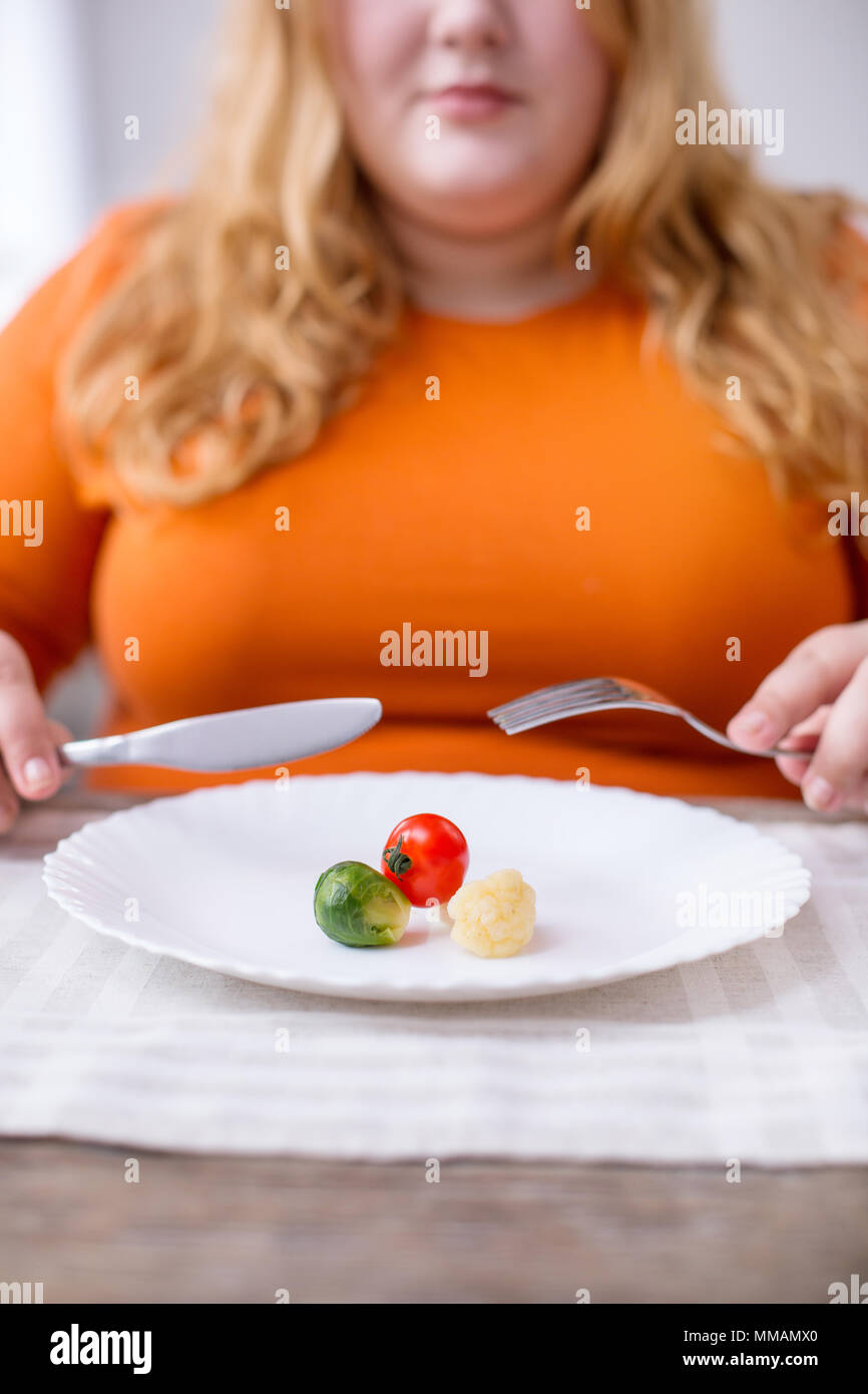 Young fat eating healthy food Stock Photo