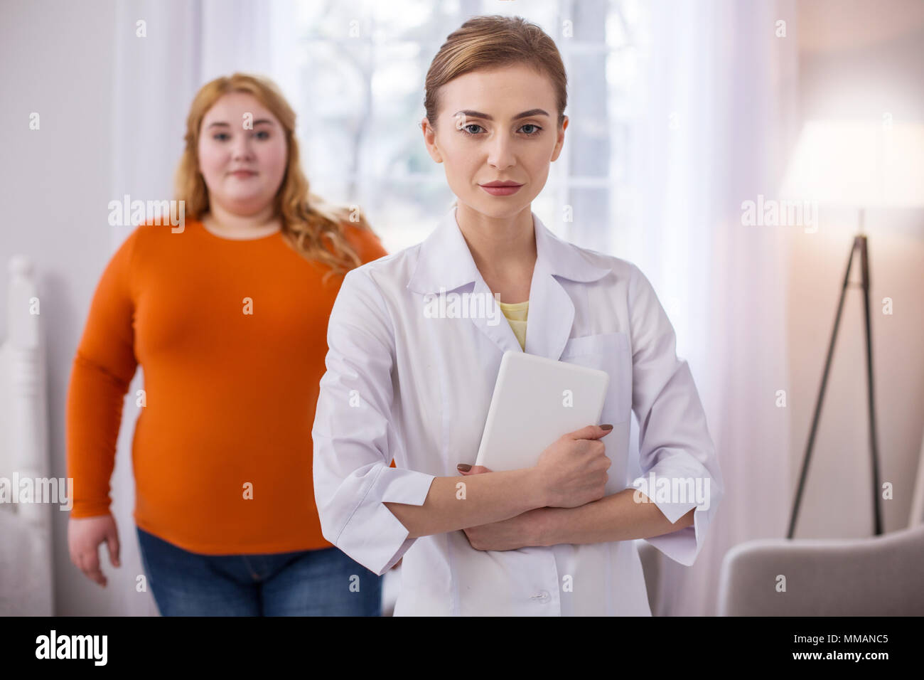 Determined nutrition specialist holding her tablet Stock Photo