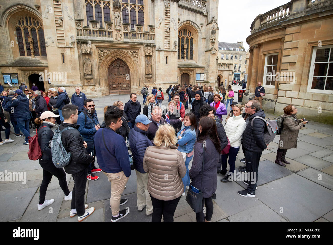abbey churchyard in front of bath abbey busy with tourists and walking tour groups Bath England UK Stock Photo