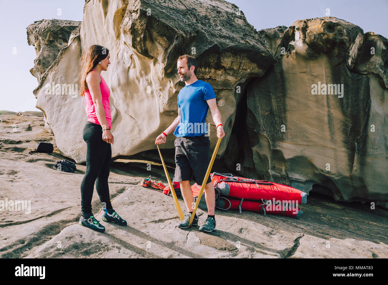 Young couple of climbers doing stretching exercises before climbing Stock Photo Alamy