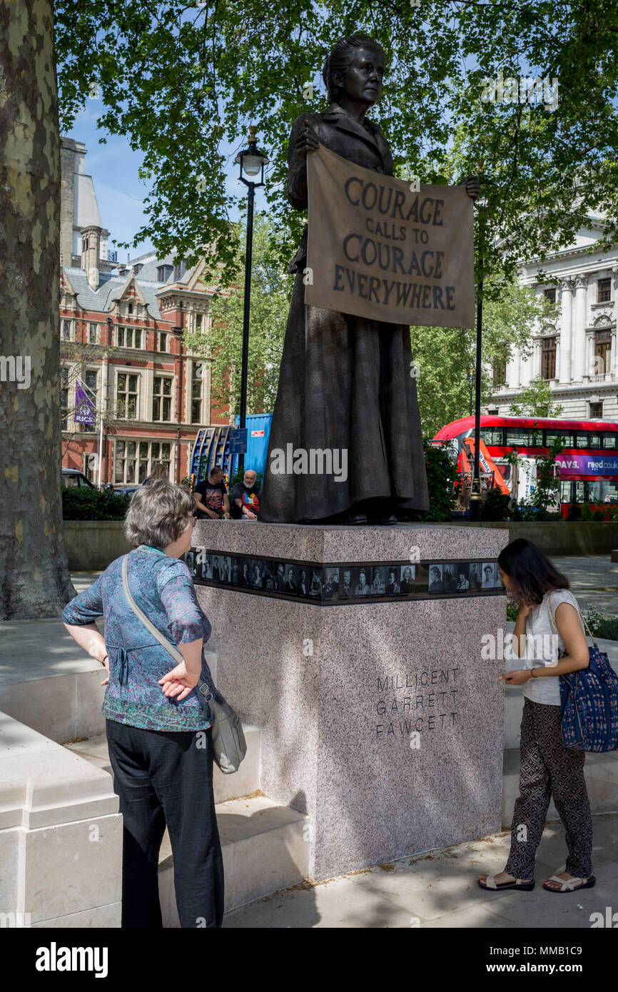 Admirers of suffragist Millicent Garrett Fawcett's statue, the first woman to appear among an all-male Parliament Square, on 9th May 2018, in London, England. Dame Millicent Garrett Fawcett GBE was a British feminist, intellectual, political leader, activist and writer. She is primarily known for her work as a campaigner for women's suffrage Stock Photo