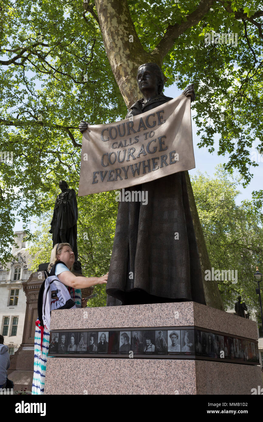 Admirers of suffragist Millicent Garrett Fawcett's statue, the first woman to appear among an all-male Parliament Square, on 9th May 2018, in London, England. Dame Millicent Garrett Fawcett GBE was a British feminist, intellectual, political leader, activist and writer. She is primarily known for her work as a campaigner for women's suffrage Stock Photo