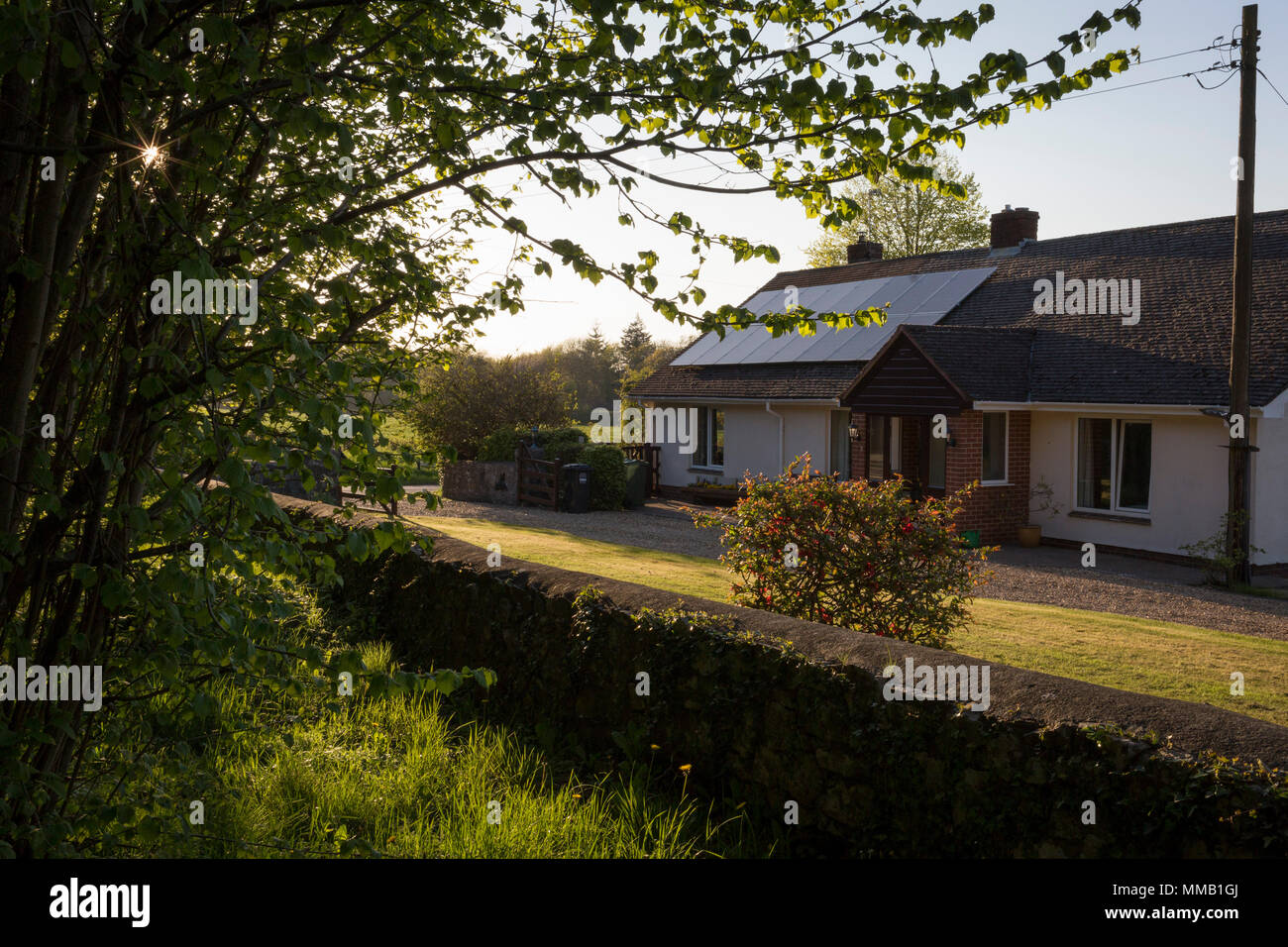 A rural bungalow and its walled boundary, on 5th May 2018, in Wrington
