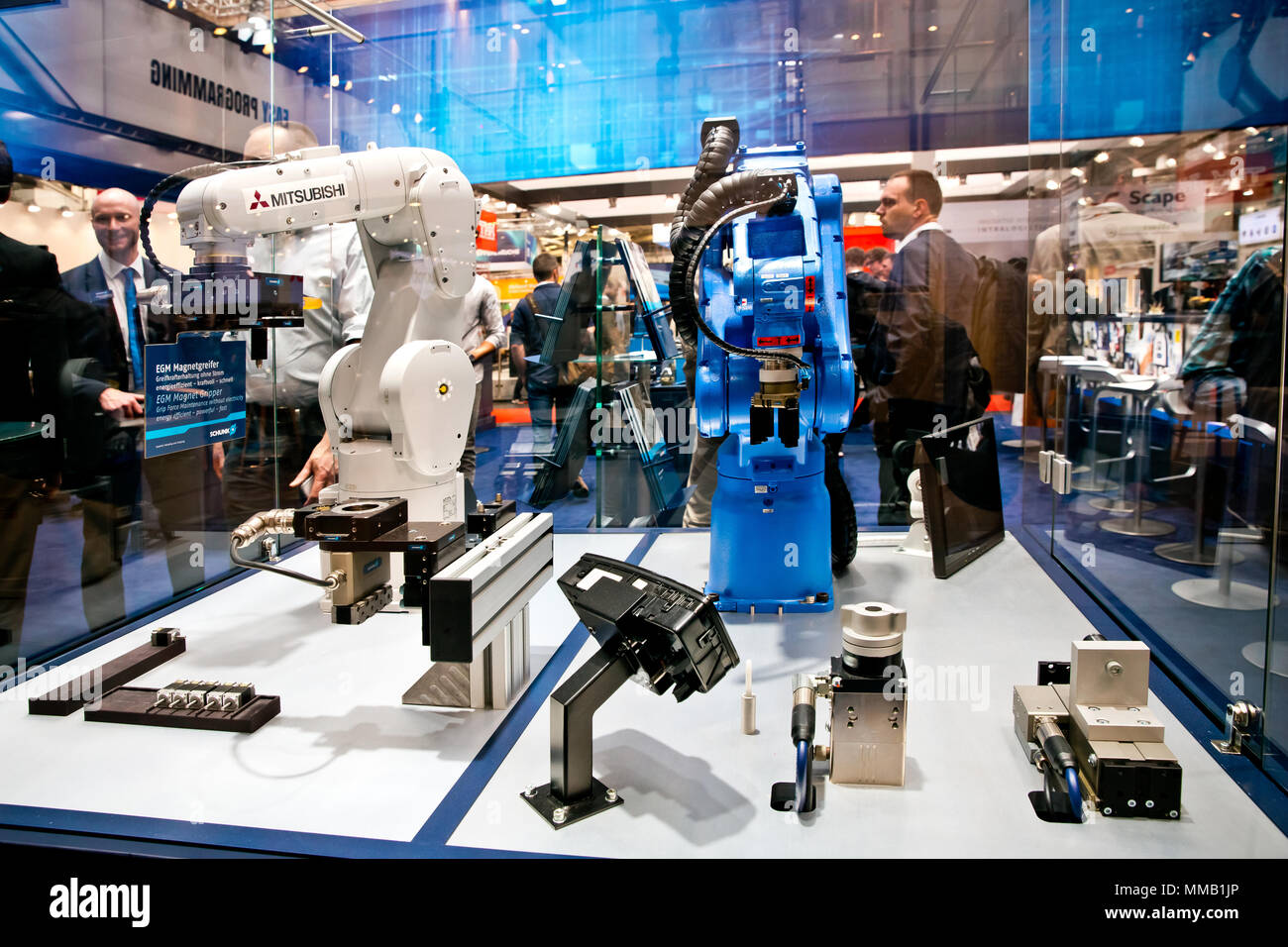 Hannover, Germany - April, 2018: Mitsubishi and Yaskawa robot arms on Schunk stand on Messe fair in Hannover, Germany Stock Photo