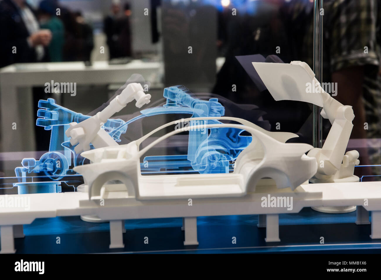 Hannover, Germany - April, 2018: Simulating of car manufacturing by robots, digital twin of the production on Siemens stand on Messe fair in Hannover, Stock Photo