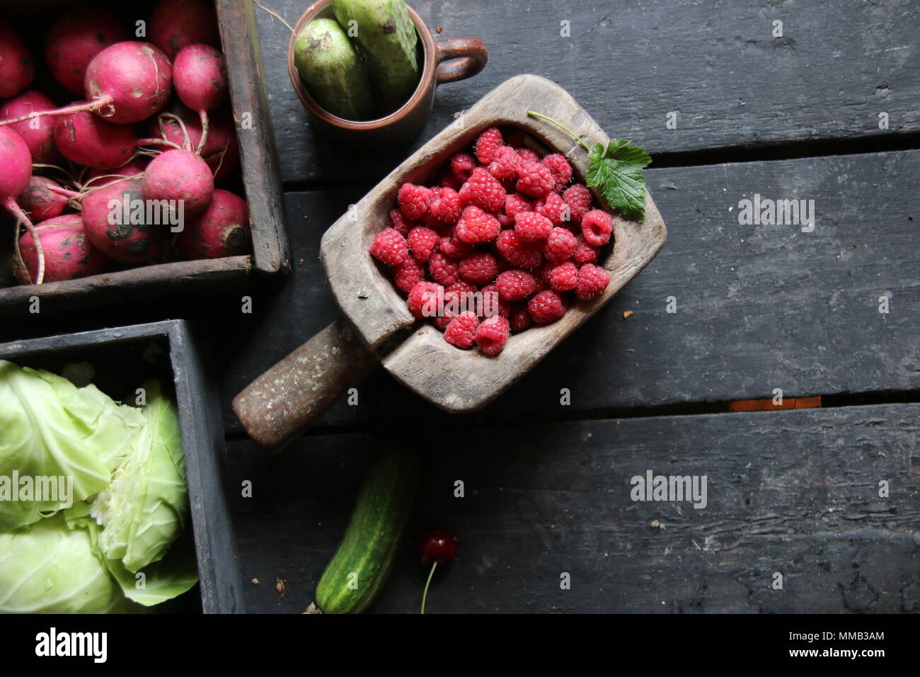 Healthy eating, food, dieting and vegetarian concept. Berries and vegetables on the table. Stock Photo