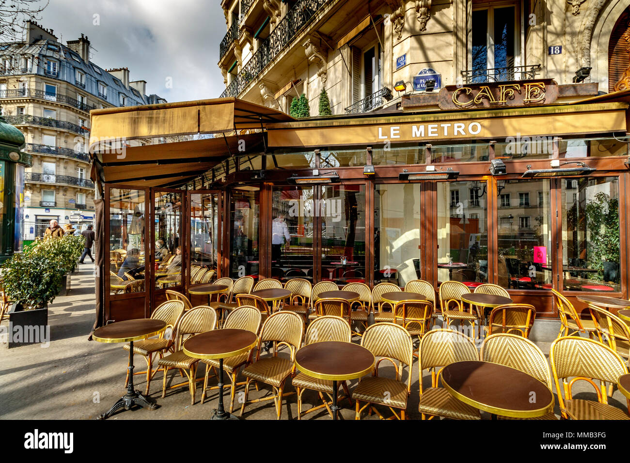 Tables and chairs outside Le Metro  Café and restaurant  on Boulevard Saint-Germain , Paris ,France Stock Photo