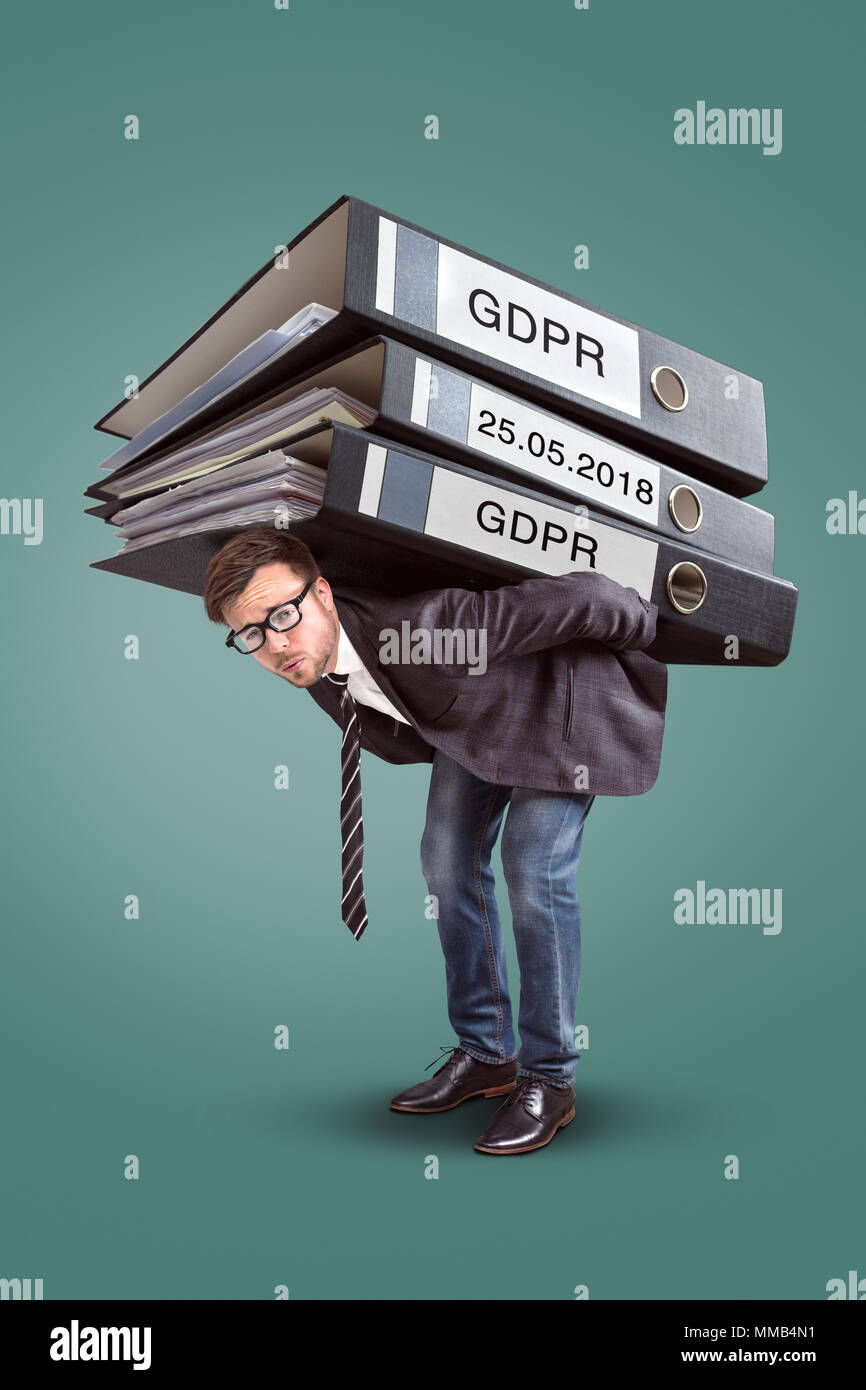 Man carrying an enormous stack of GDPR files Stock Photo