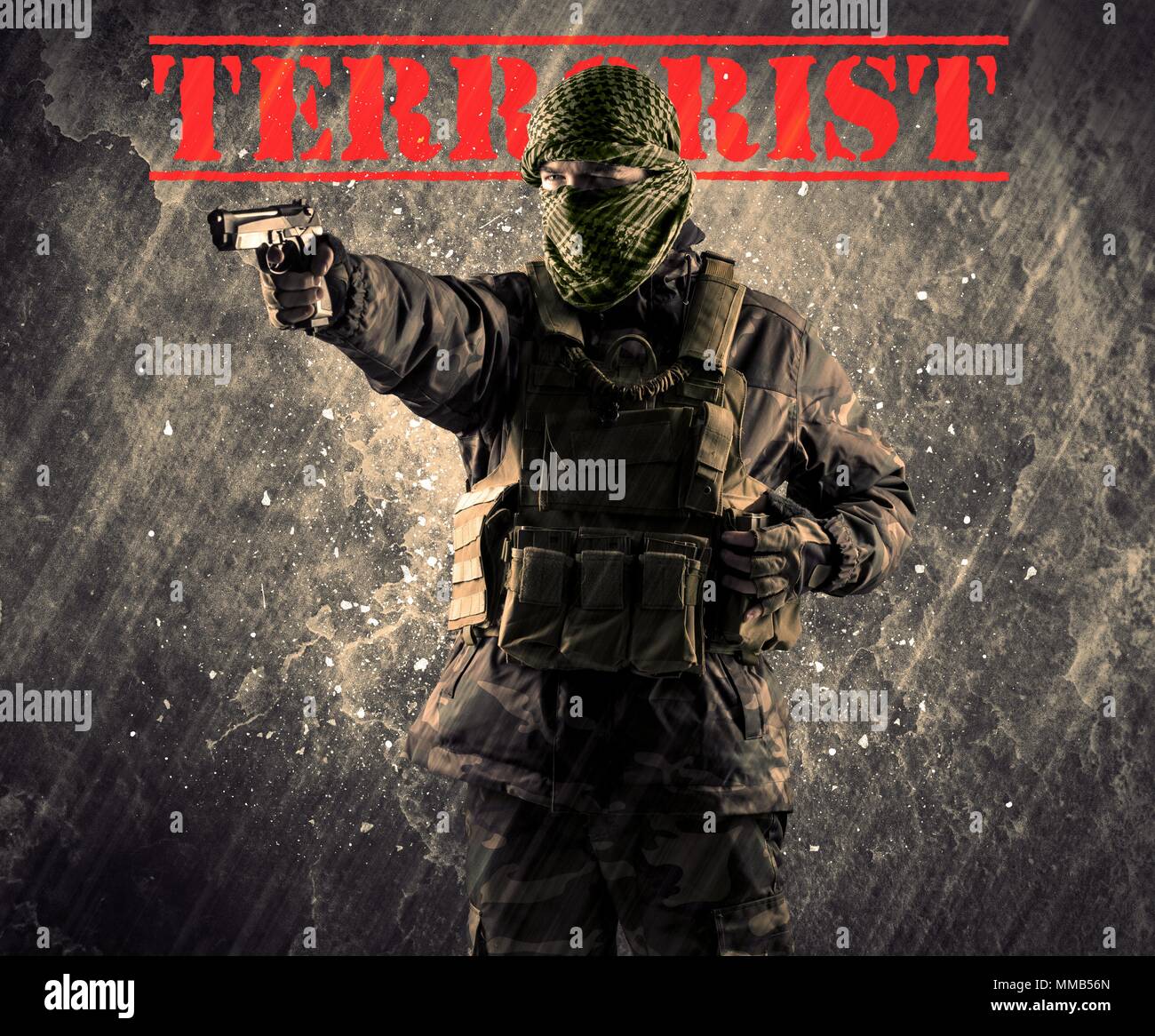 Portrait of dangerous masked and armed man with terrorist sign on grungy background Stock Photo