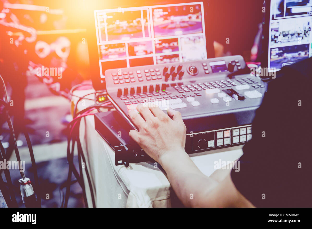 Professional video editor footage switching on stage duty vintage tone. Stock Photo
