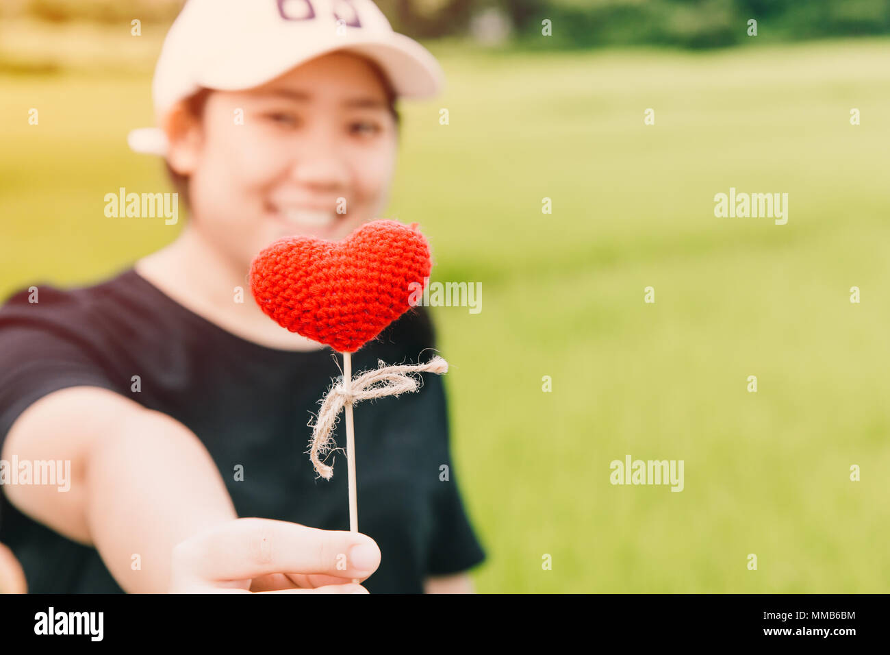 Cute fat girl teen giving heart love concept with space for text Stock Photo
