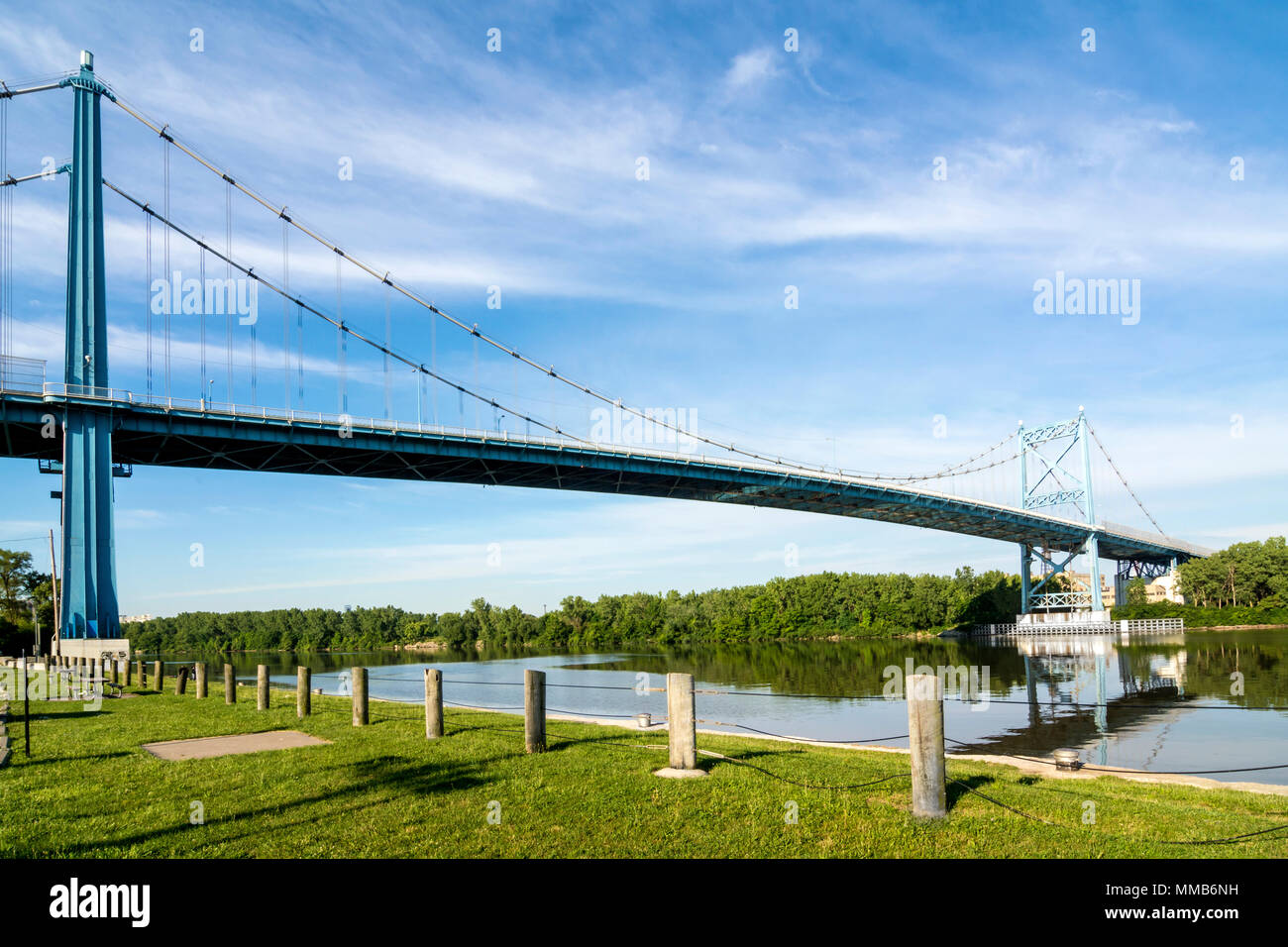 A panoramic view of downtown Toledo Ohio's Anthony Wayne Bridge or High-Level bridge that crosses the Maumee River.A beautiful blue sky with clouds. Stock Photo