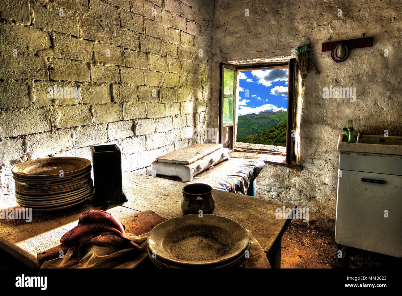 Room with a view -  Abandoned house kitchen in the alpine village of Mindino, municipality of Garessio,Cuneo province, Piedmont, North Italy, Europe. Stock Photo