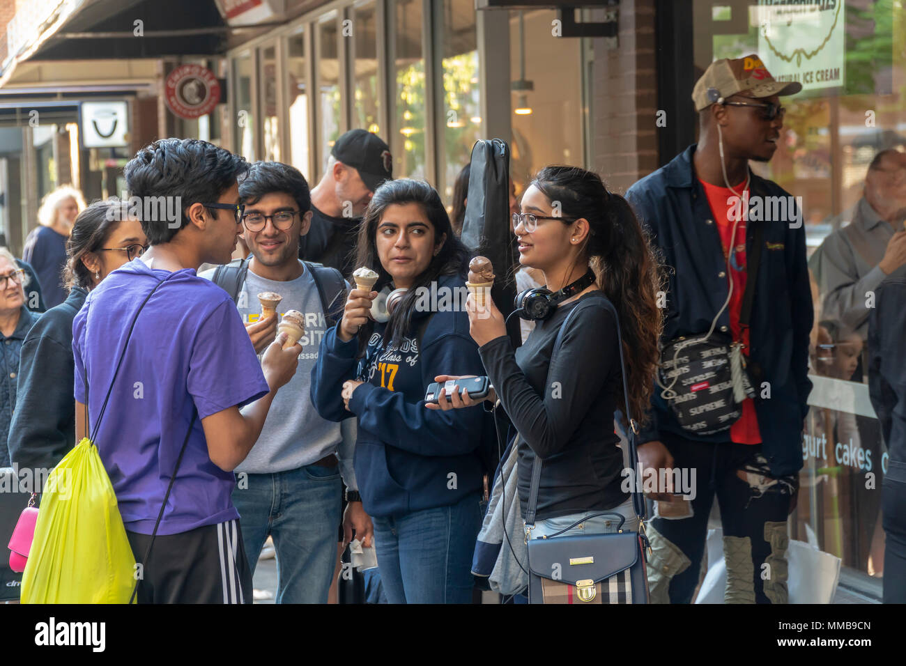 Crowds of millennials outside the HÃ¤agen-Dazs store in Greenwich Village in New York on their 'Free Cone Day', Tuesday, May 8, 2018. Started by Reuben and Rose Mattus in 1960 the company is one of the first brands to create the market for premium ice cream. HÃ¤agen-Dazs is a brand of General Mills. (Â© Richard B. Levine) Stock Photo
