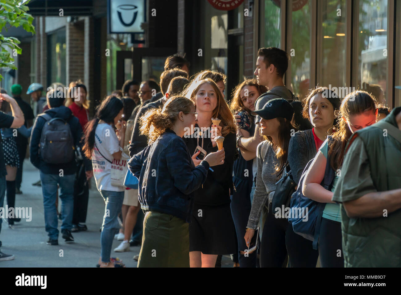 Crowds of millennials outside the HÃ¤agen-Dazs store in Greenwich Village in New York on their 'Free Cone Day', Tuesday, May 8, 2018. Started by Reuben and Rose Mattus in 1960 the company is one of the first brands to create the market for premium ice cream. HÃ¤agen-Dazs is a brand of General Mills. (Â© Richard B. Levine) Stock Photo