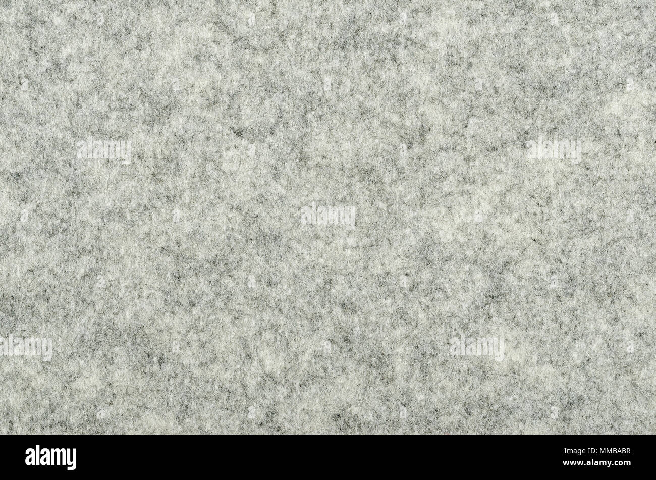 Gray felt surface. Textile material, made of matted synthetic fibers. White, gray and black acrylic pressed together. Fabric pattern. Background. Stock Photo