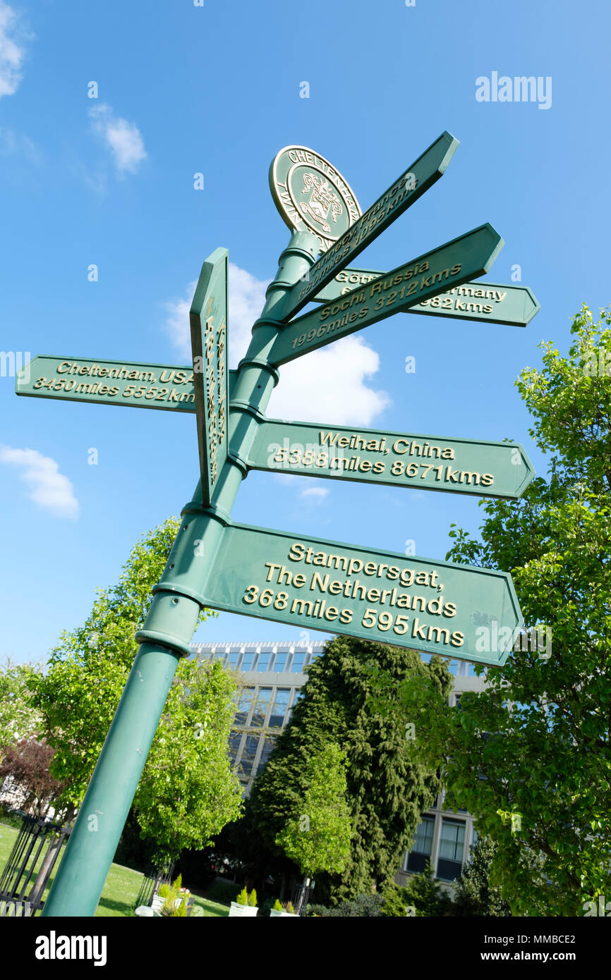 Fingerpost showing distances from Cheltenham to its twin towns. Imperial Gardens, Cheltenham, UK. Stock Photo