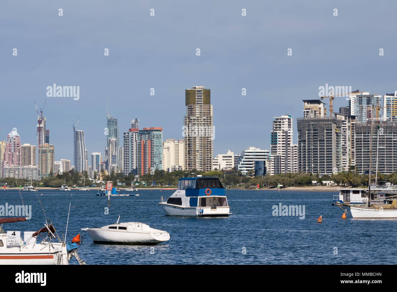 Boats moored at the Gold Coast with High rise in the background. Stock Photo